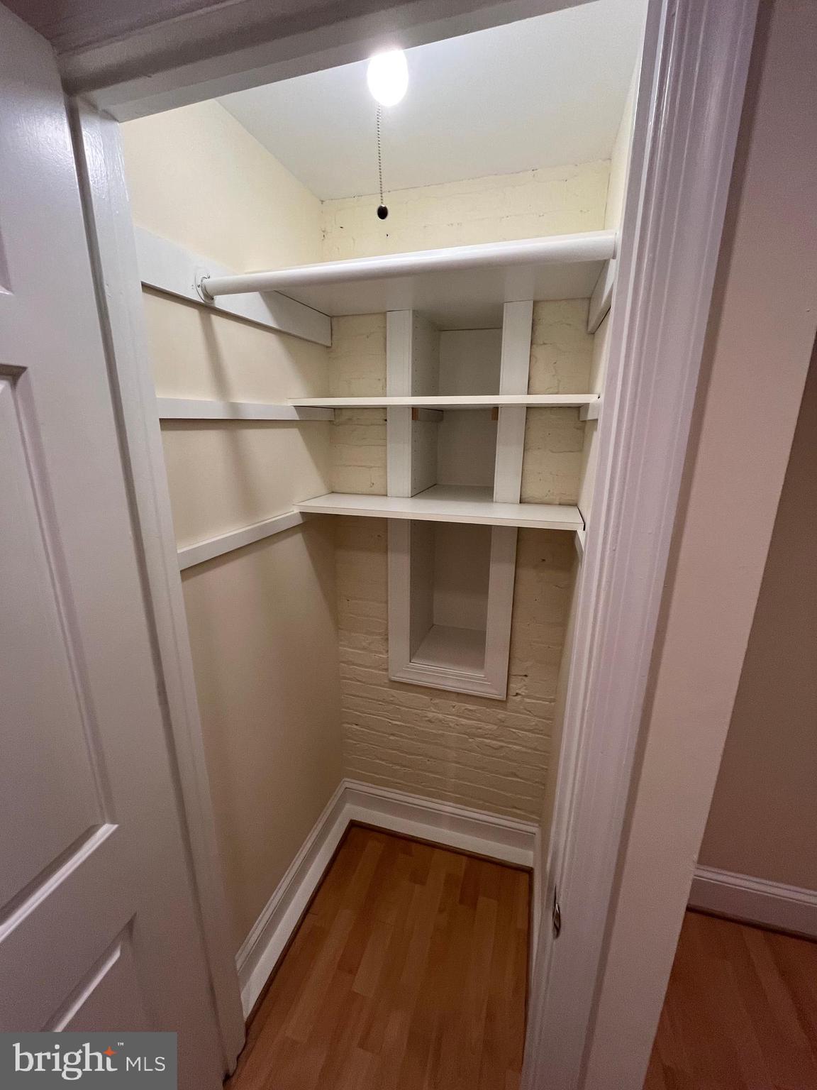 1835 16th Street Northwest, Unit 1 Washington, DC 20009 - Photo 8 of 32 a view of a room with rack on the wall and a window