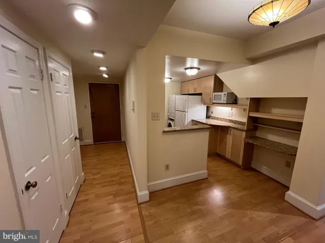 a kitchen with cabinets and stainless steel appliances