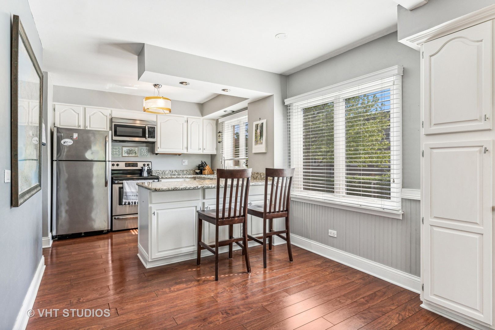 2400 West Talcott Road, Unit 121 Park Ridge, IL 60068 - Photo 4 of 10 a kitchen with stainless steel appliances granite countertop a refrigerator a microwave oven a sink dishwasher and white cabinets with wooden floor