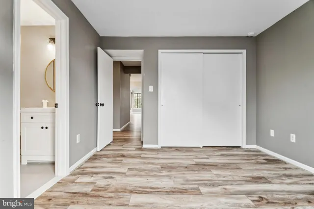 a view of a room with wooden floor and white doors