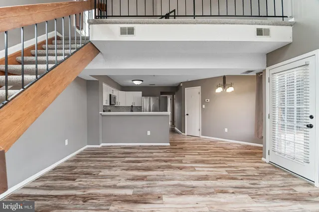 a view of a room with wooden floor