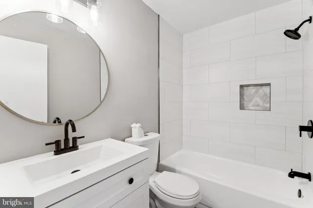 a bathroom with a sink a toilet and bathtub