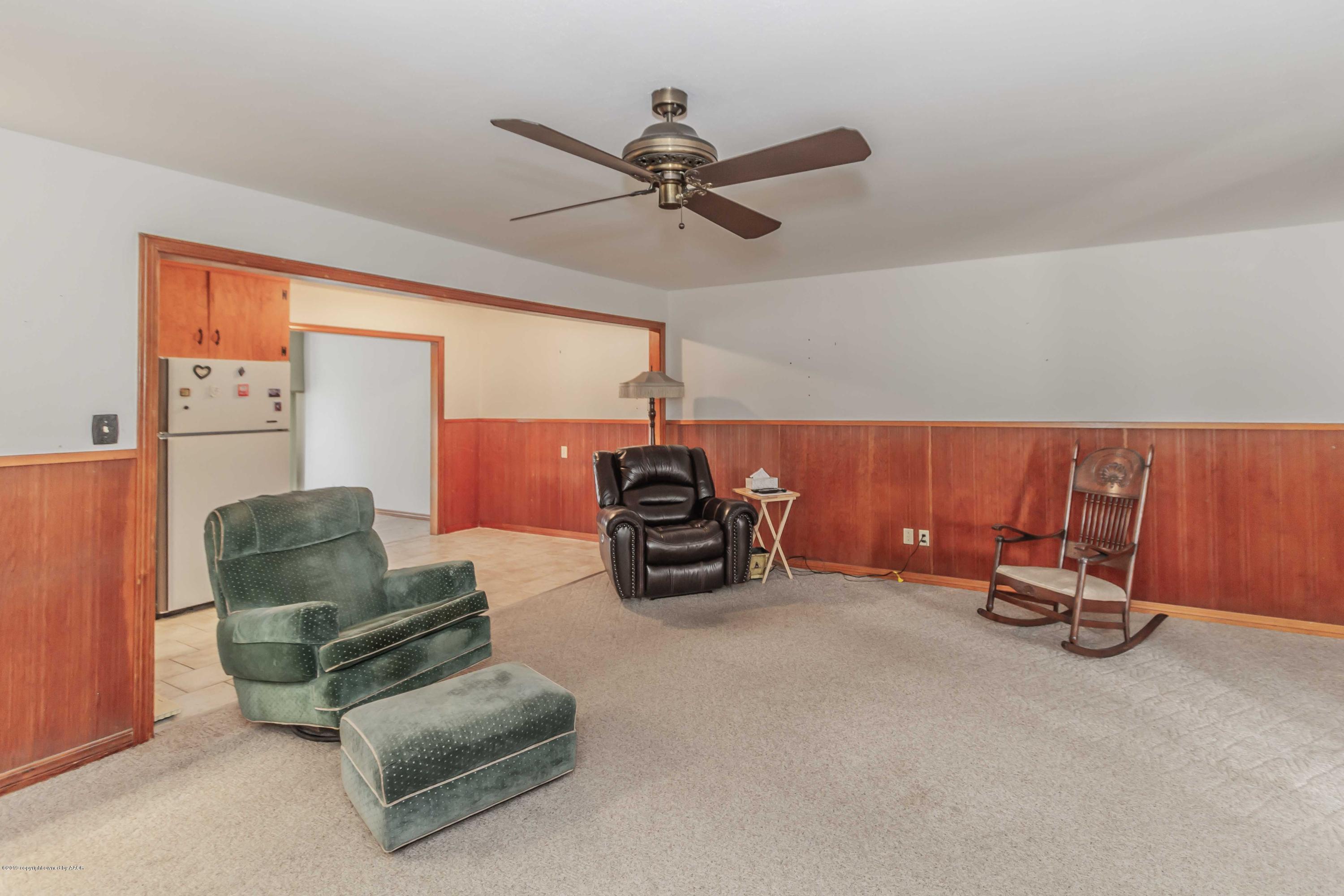 3613 Cline Road Amarillo, TX 79110 - Photo 15 of 36 a living room with furniture a ceiling fan and a rug