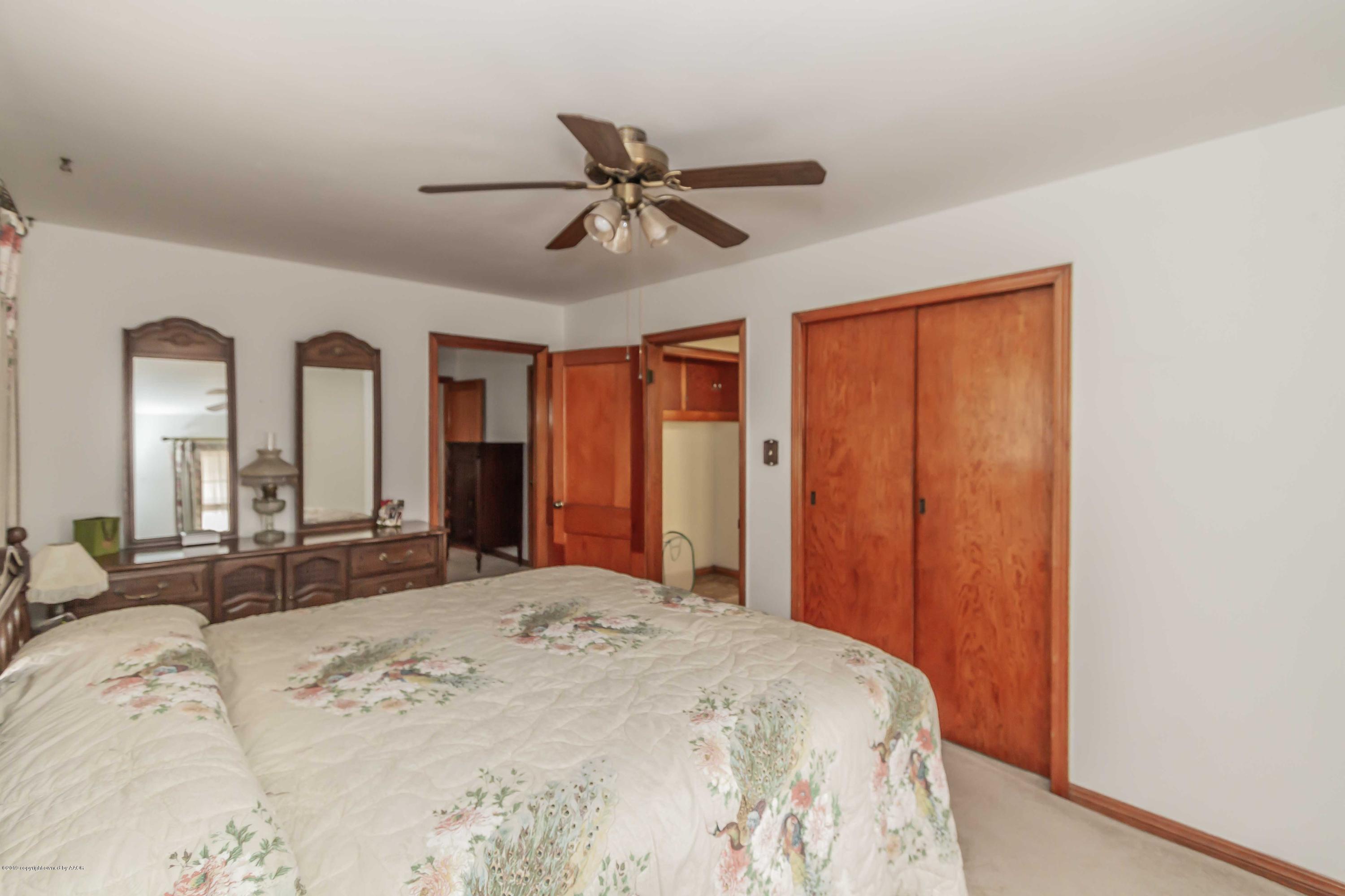 3613 Cline Road Amarillo, TX 79110 - Photo 21 of 36 a bedroom with a large bed and large window