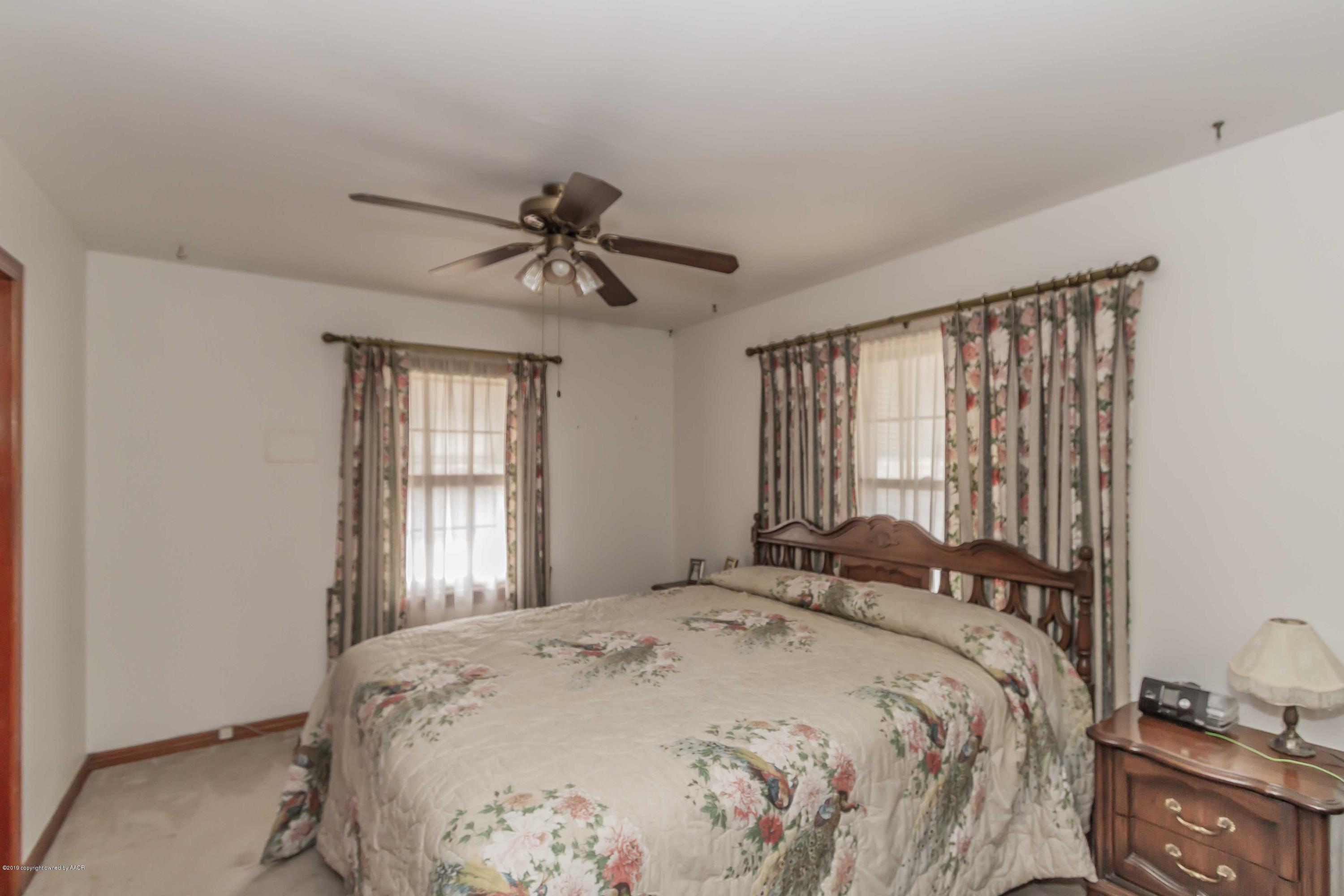 3613 Cline Road Amarillo, TX 79110 - Photo 23 of 36 a bedroom with a large bed and a window