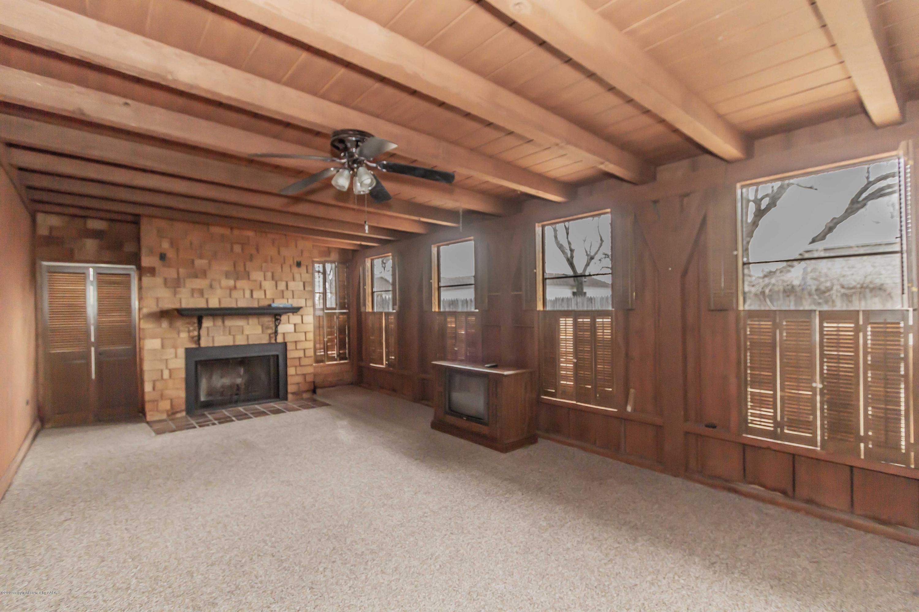 3613 Cline Road Amarillo, TX 79110 - Photo 31 of 36 an empty room with furniture and a fireplace