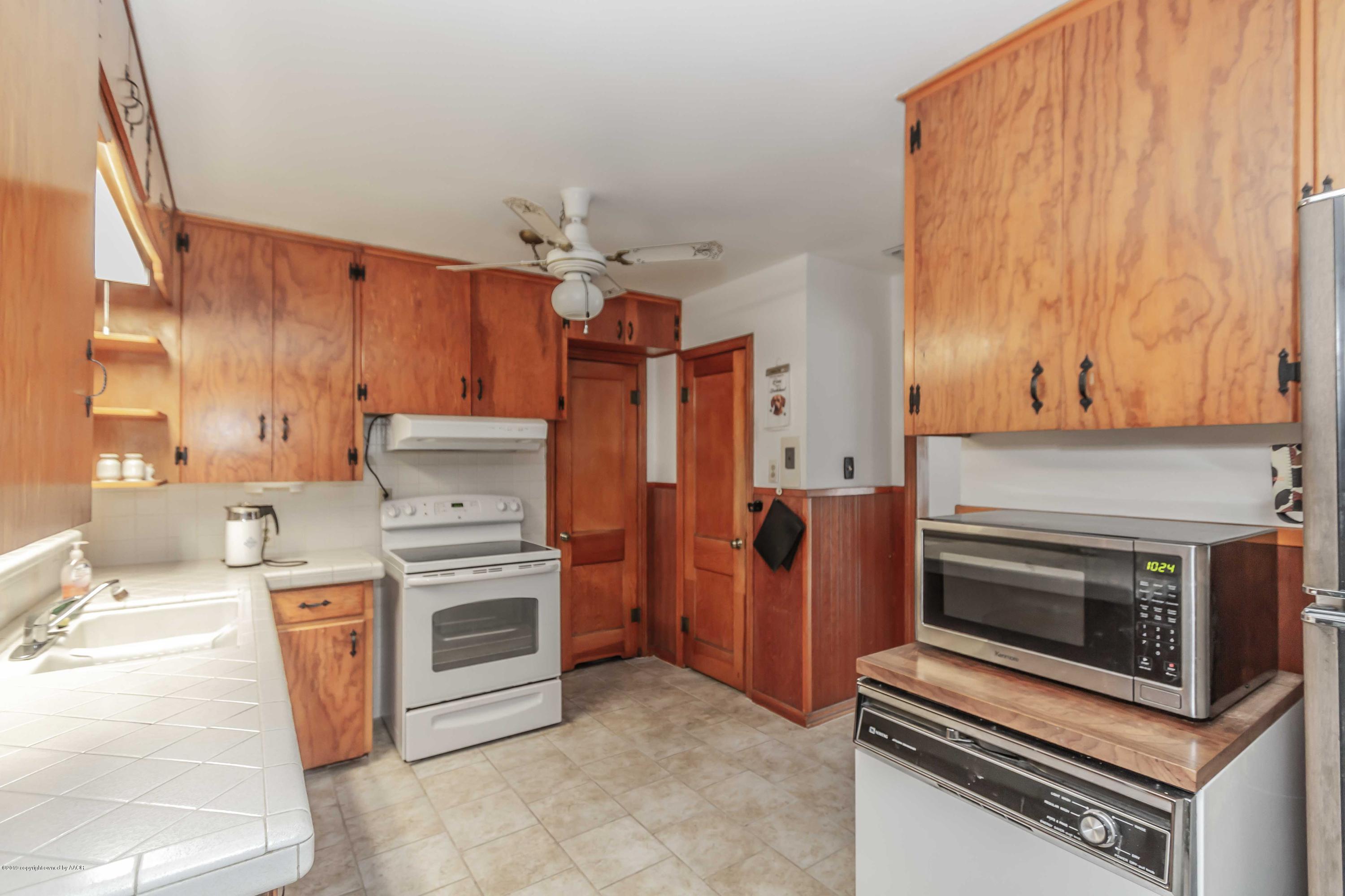 3613 Cline Road Amarillo, TX 79110 - Photo 9 of 36 a kitchen with a stove and a microwave