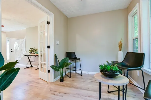 a view of a house with a small yard and wooden fence