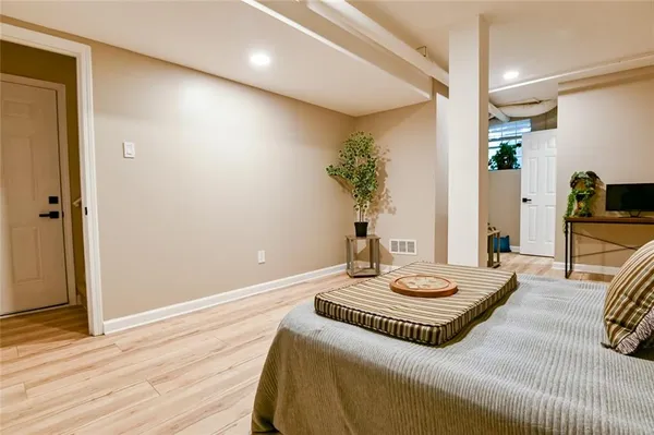 a living room with furniture and a potted plant