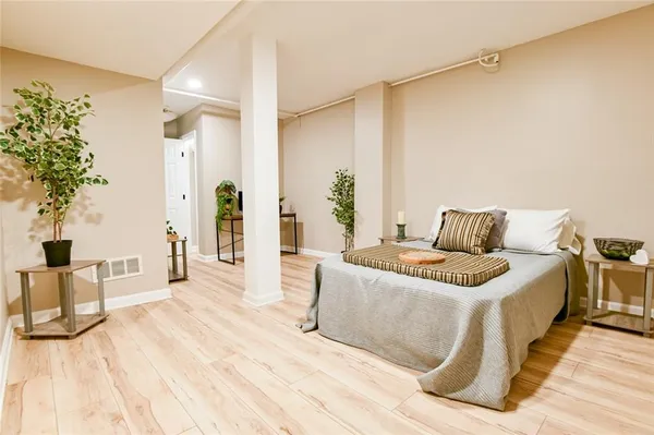 a bathroom with a granite countertop sink a large mirror and a window