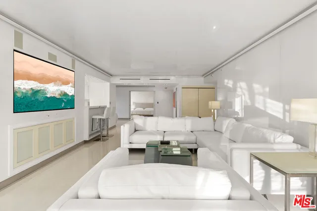 a living room with furniture large window and a flat screen tv