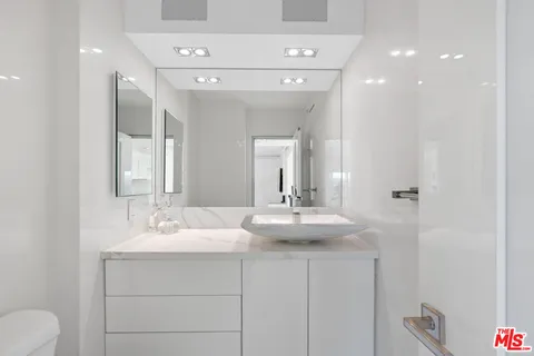 a bathroom with a double vanity sink and a mirror