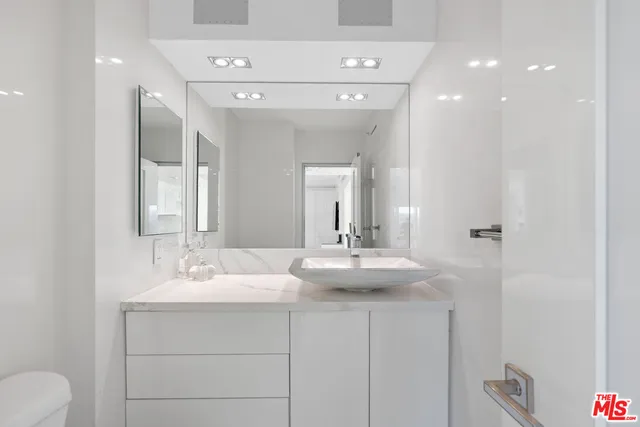 a bathroom with a double vanity sink and a mirror