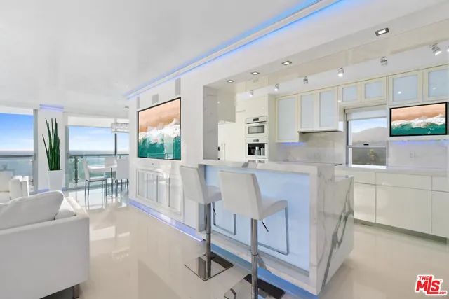 a kitchen with counter top space and windows