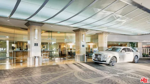 a view of a cars park in front of a building