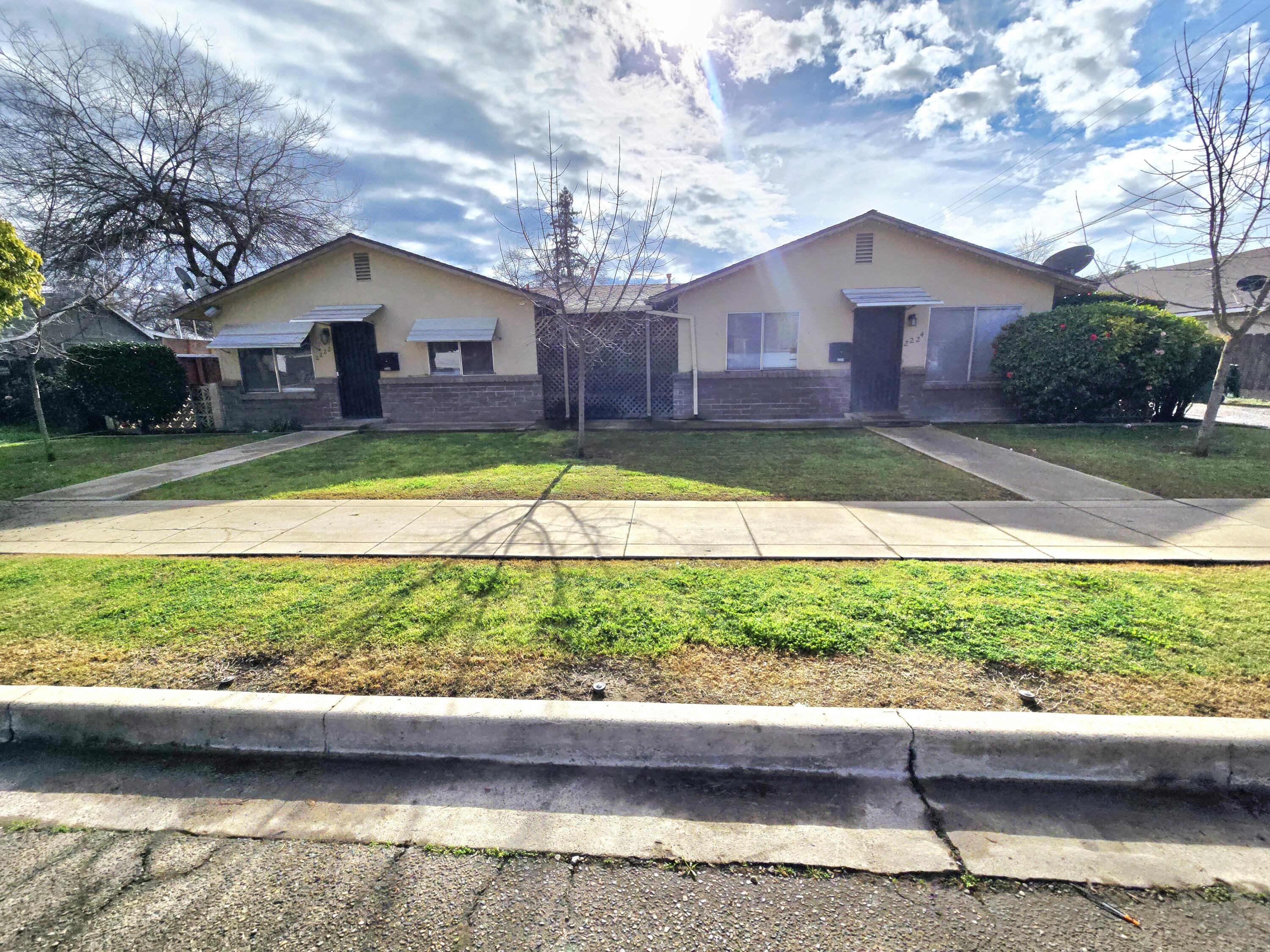 2222-2224 11th Street Reedley, CA 93654 - Photo 2 of 11 a front view of a house with a yard