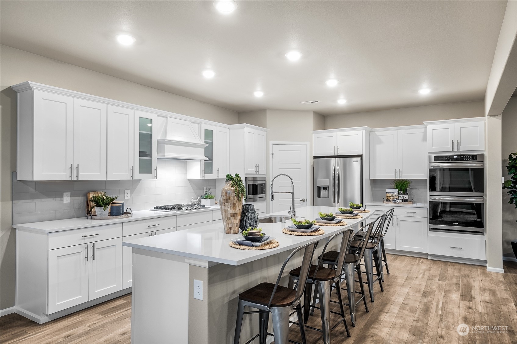 4019 233rd Street Southeast, Unit 9 Bothell, WA 98021 - Photo 5 of 18 a kitchen with stainless steel appliances a sink a stove a refrigerator cabinets and a dining table