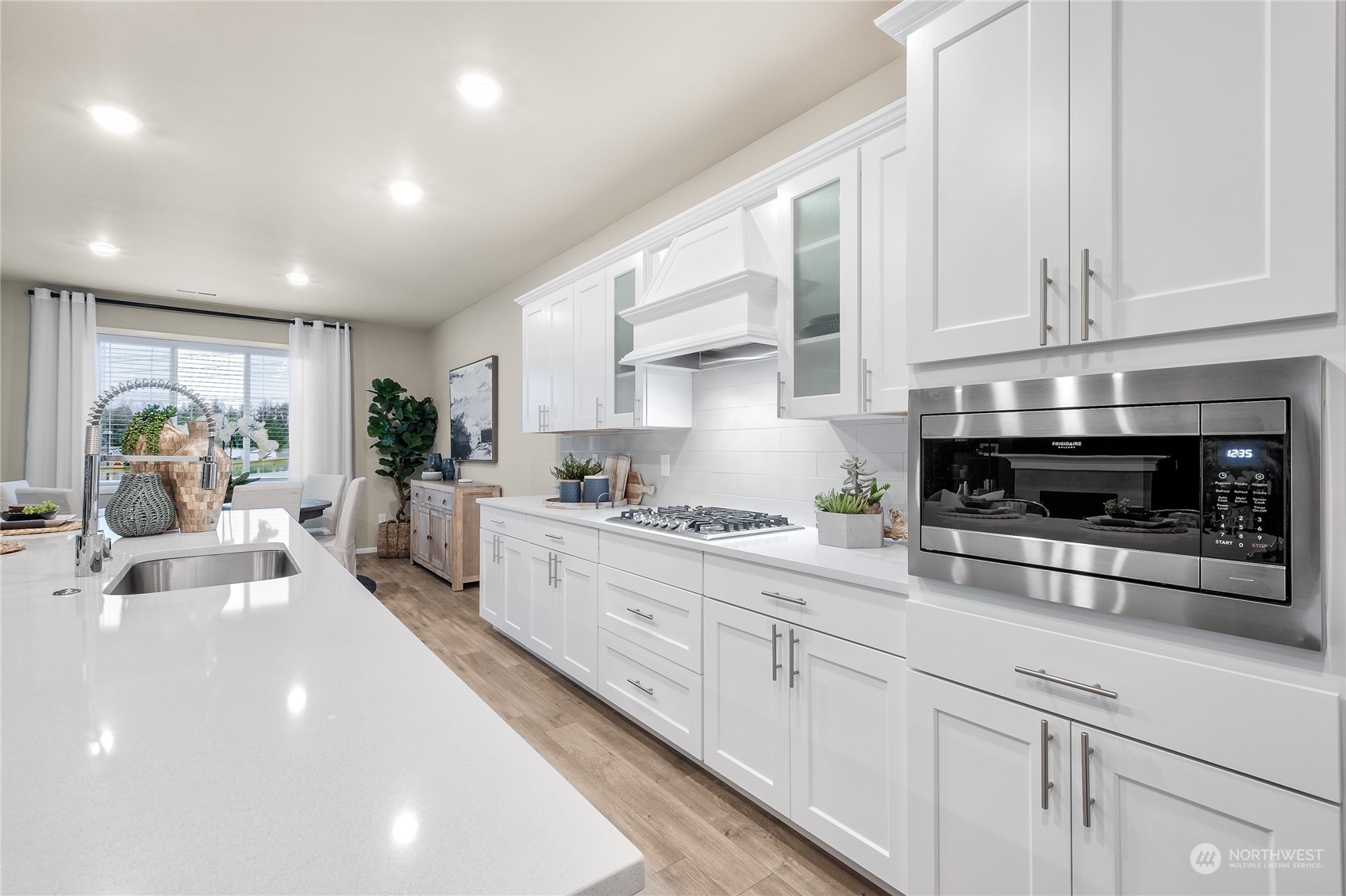 4019 233rd Street Southeast, Unit 9 Bothell, WA 98021 - Photo 6 of 18 a kitchen with stainless steel appliances granite countertop a stove a sink and white cabinets