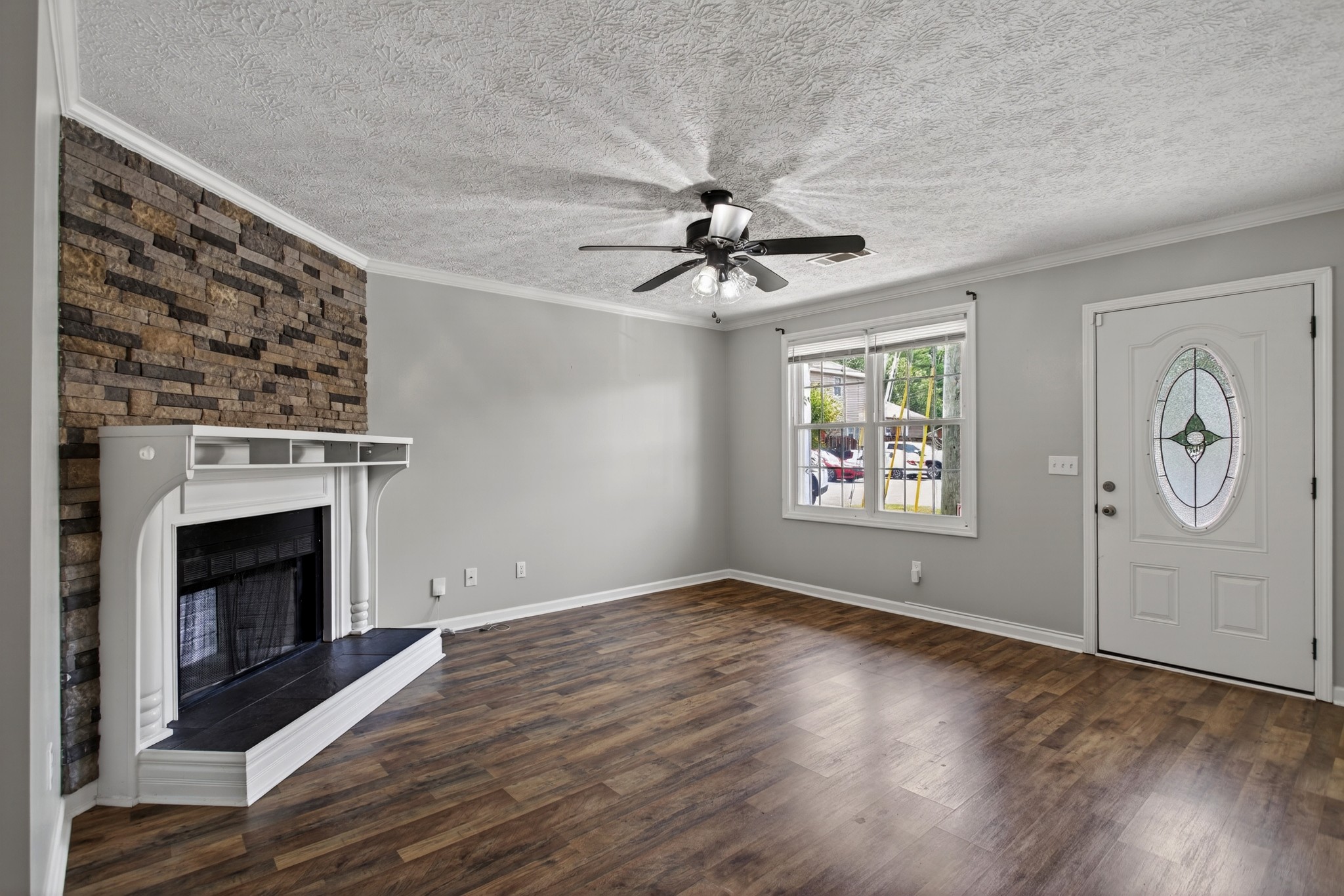 430 Walton Ferry Road, Unit 200 Hendersonville, TN 37075 - Photo 4 of 16 an empty room with windows fireplace and wooden floor