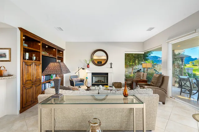 a living room with fireplace furniture and a fireplace