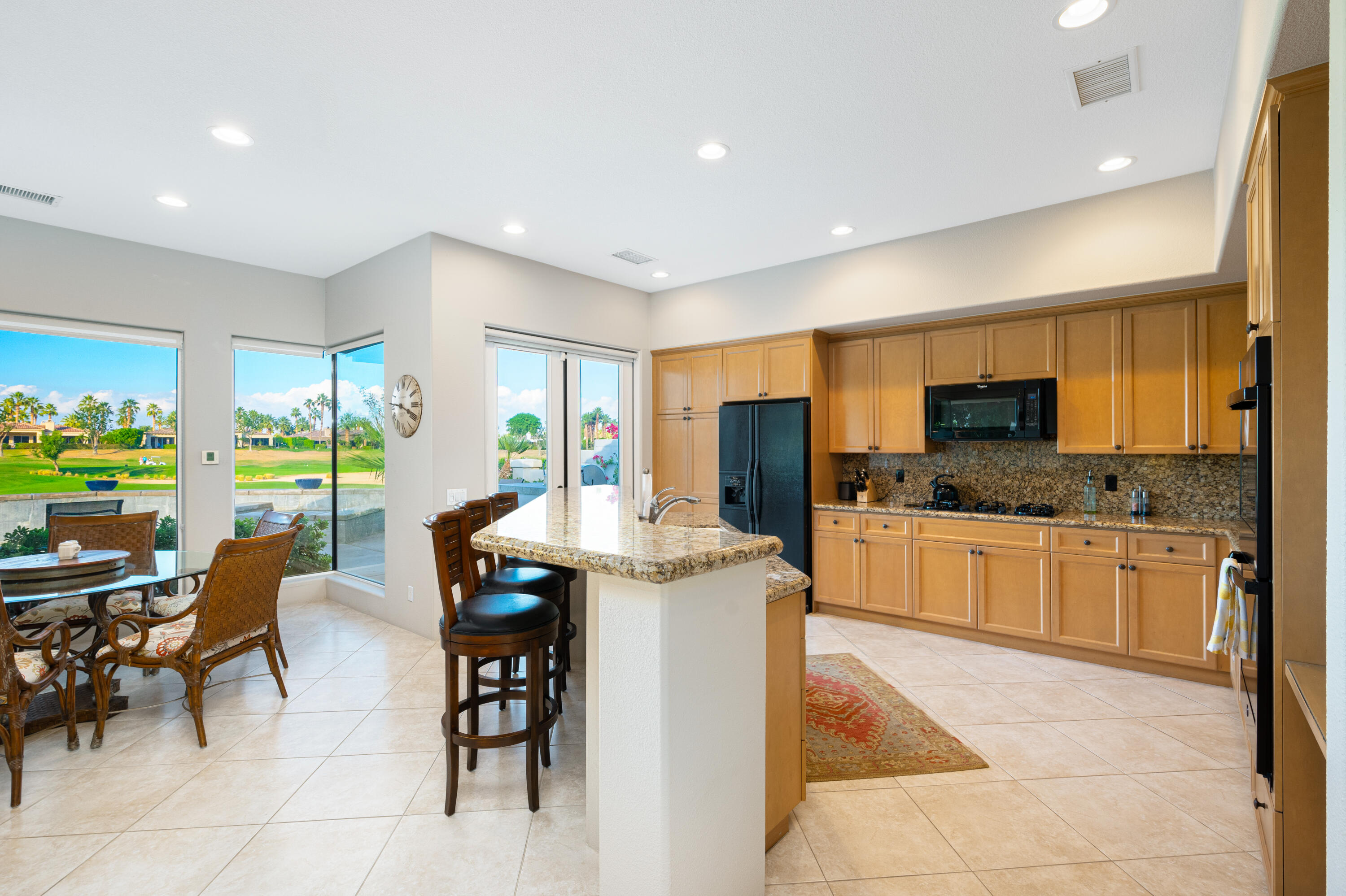 80824 Hermitage La Quinta, CA 92253 - Photo 18 of 49 a kitchen with stainless steel appliances granite countertop sink stove top oven and cabinets