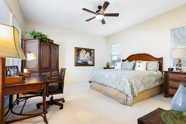 a bedroom with a bed work place and a desk