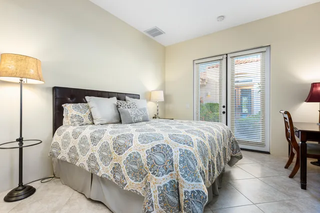 a bathroom with a granite countertop sink mirror and toilet