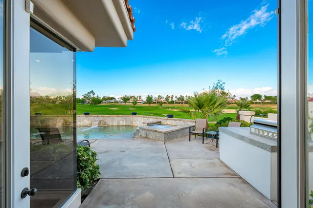 a view of a patio with a table and chairs