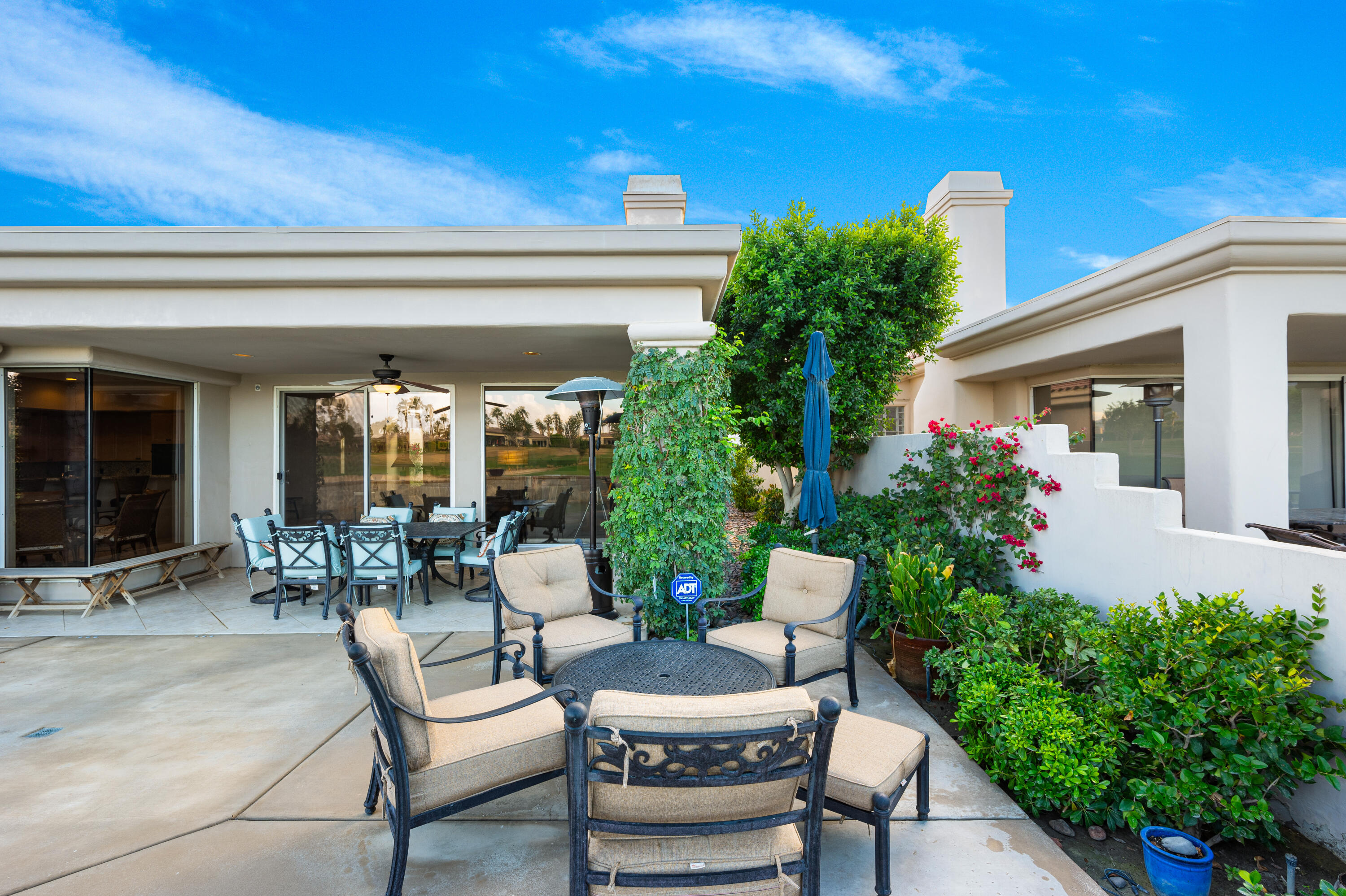80824 Hermitage La Quinta, CA 92253 - Photo 38 of 49 a view of a patio with couches table and chairs and potted plants