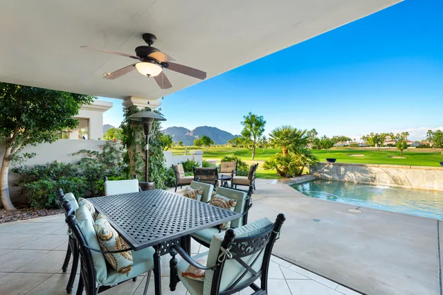 a front view of a house with a garden and yard
