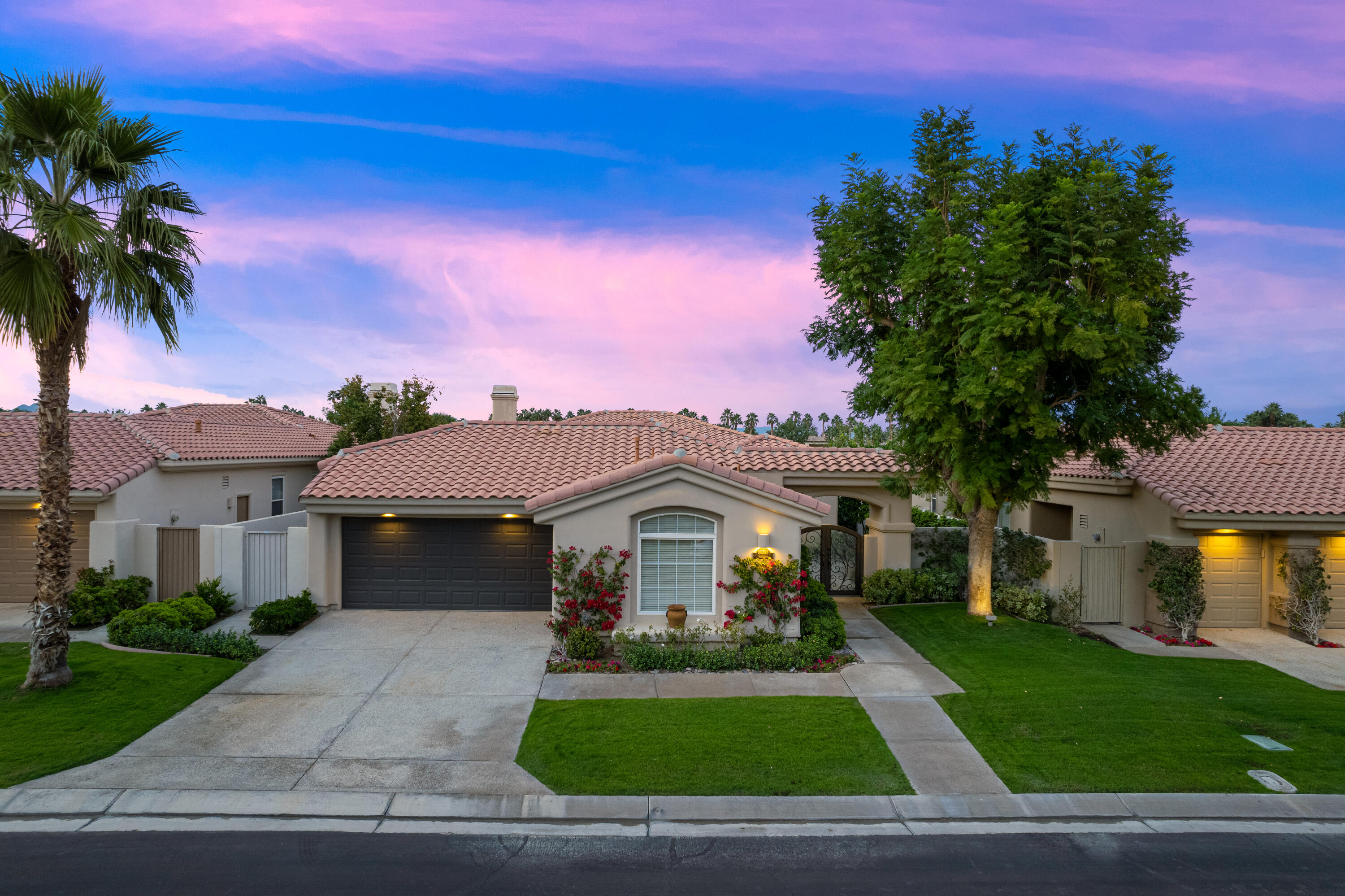 80824 Hermitage La Quinta, CA 92253 - Photo 42 of 49 a front view of a house with a garden and yard