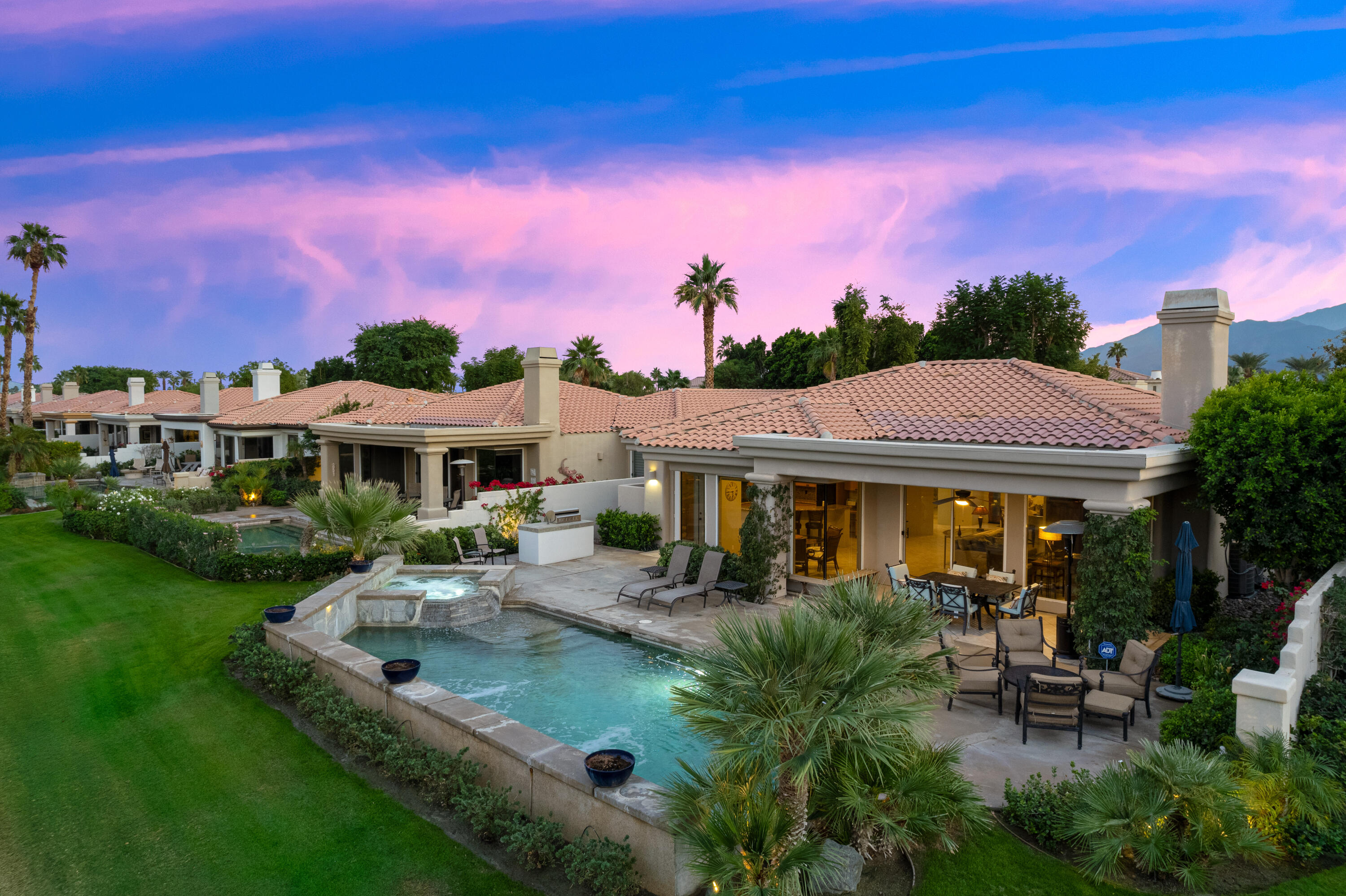 80824 Hermitage La Quinta, CA 92253 - Photo 45 of 49 a front view of a house with a garden and sitting area