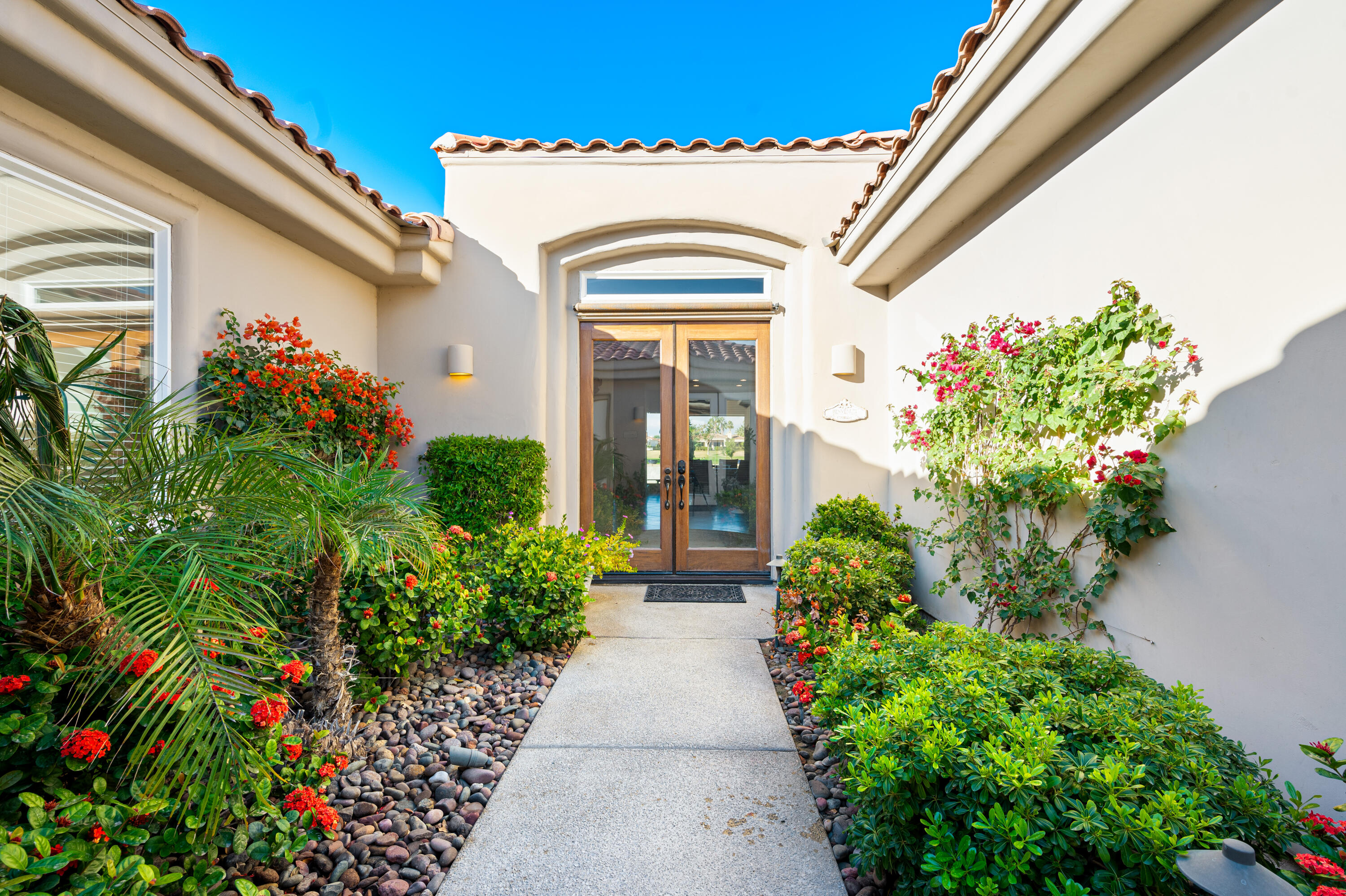 80824 Hermitage La Quinta, CA 92253 - Photo 8 of 49 a view of a pathway with flower pots
