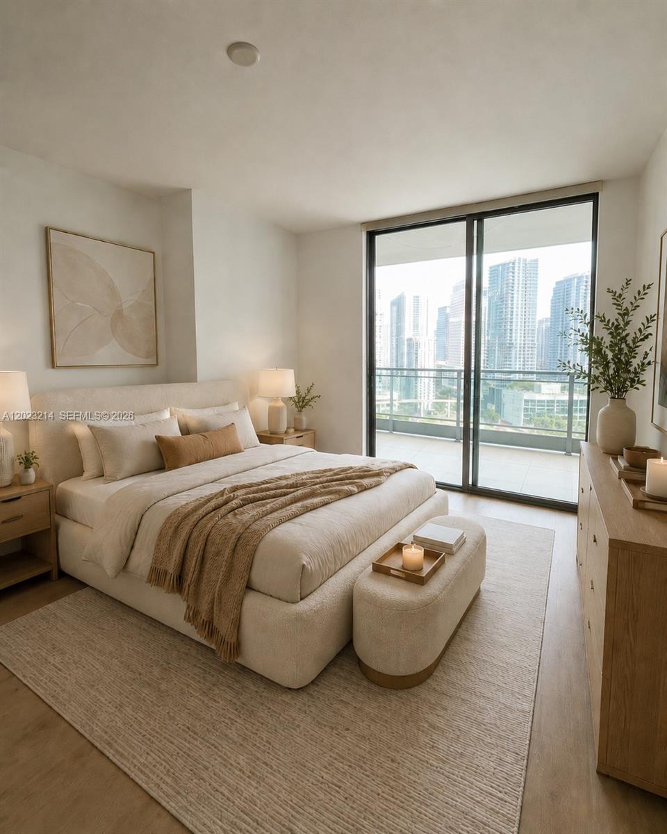 90 Southwest 3rd Street, Unit 2614 Miami, FL 33130 - Photo 9 of 13 a bedroom with a bed and glass window
