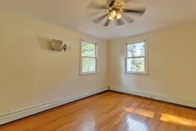 wooden floor in an empty room with a window