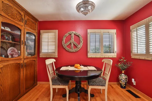 a view of a dining room with furniture and chandelier