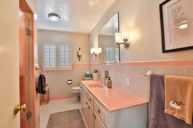 a bathroom with a tub sink and mirror