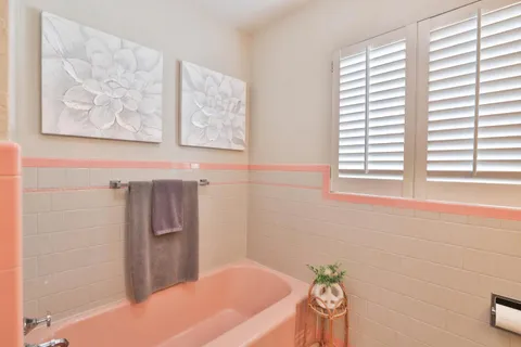 a bathroom with a bathtub and a shower