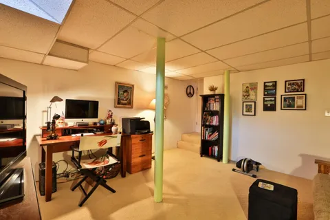 a view of a livingroom with workspace and a window