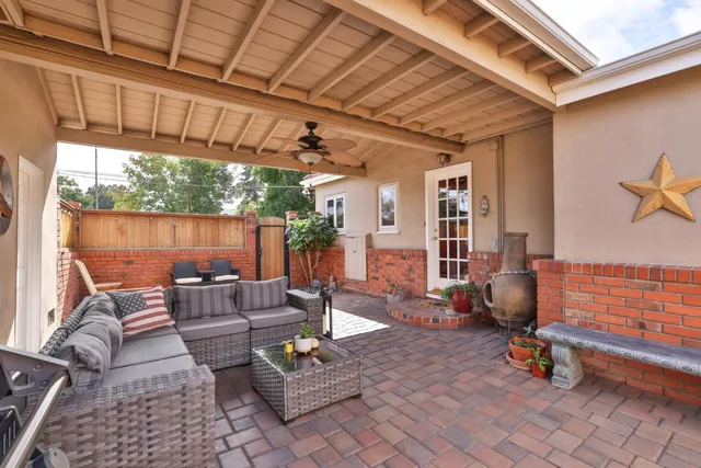 a living room with patio furniture and a wooden floor