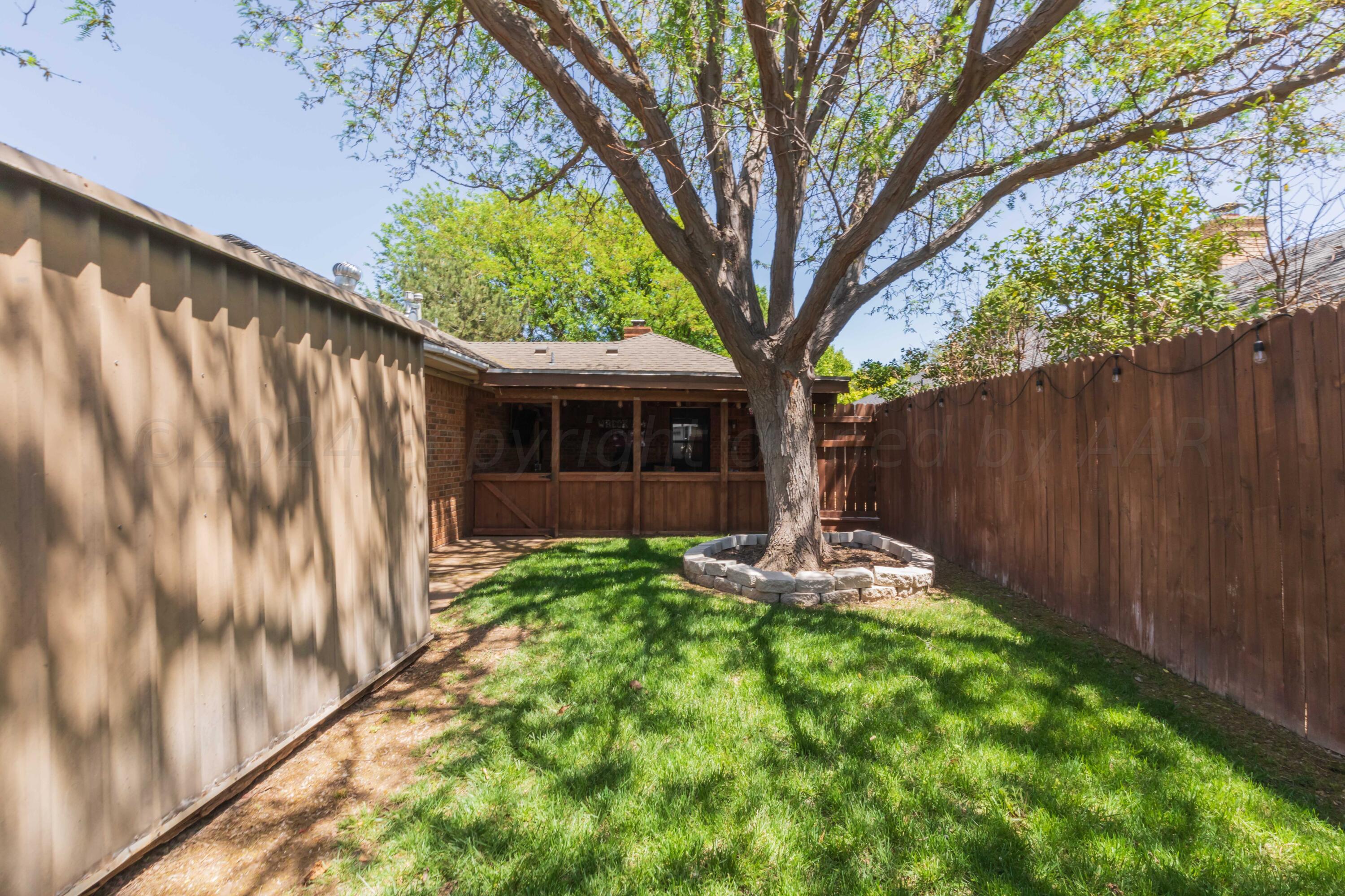 5804 Oakman Drive Amarillo, TX 79109 - Photo 20 of 48 a backyard of a house with table and chairs