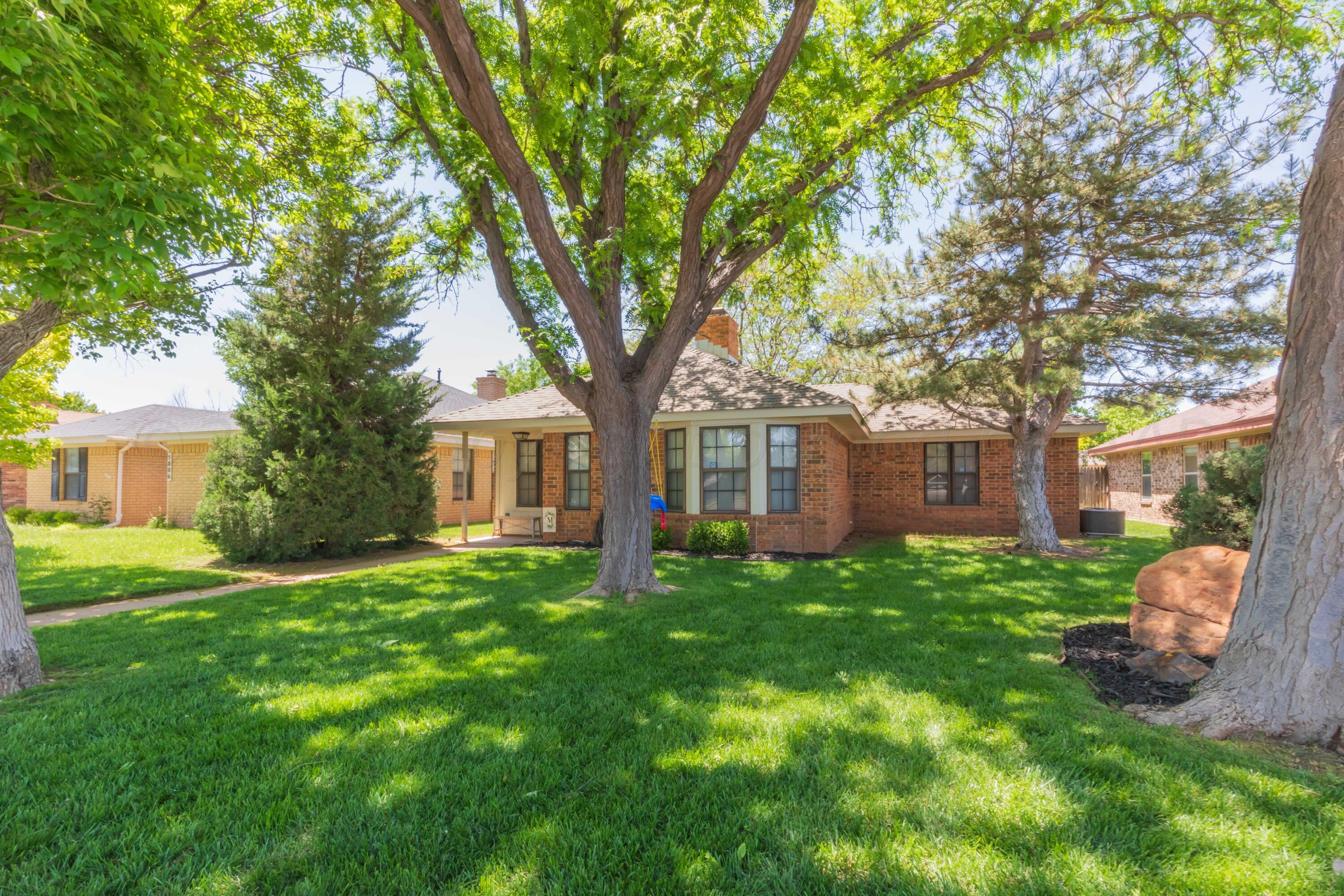 5804 Oakman Drive Amarillo, TX 79109 - Photo 3 of 48 a tree in front of a white house