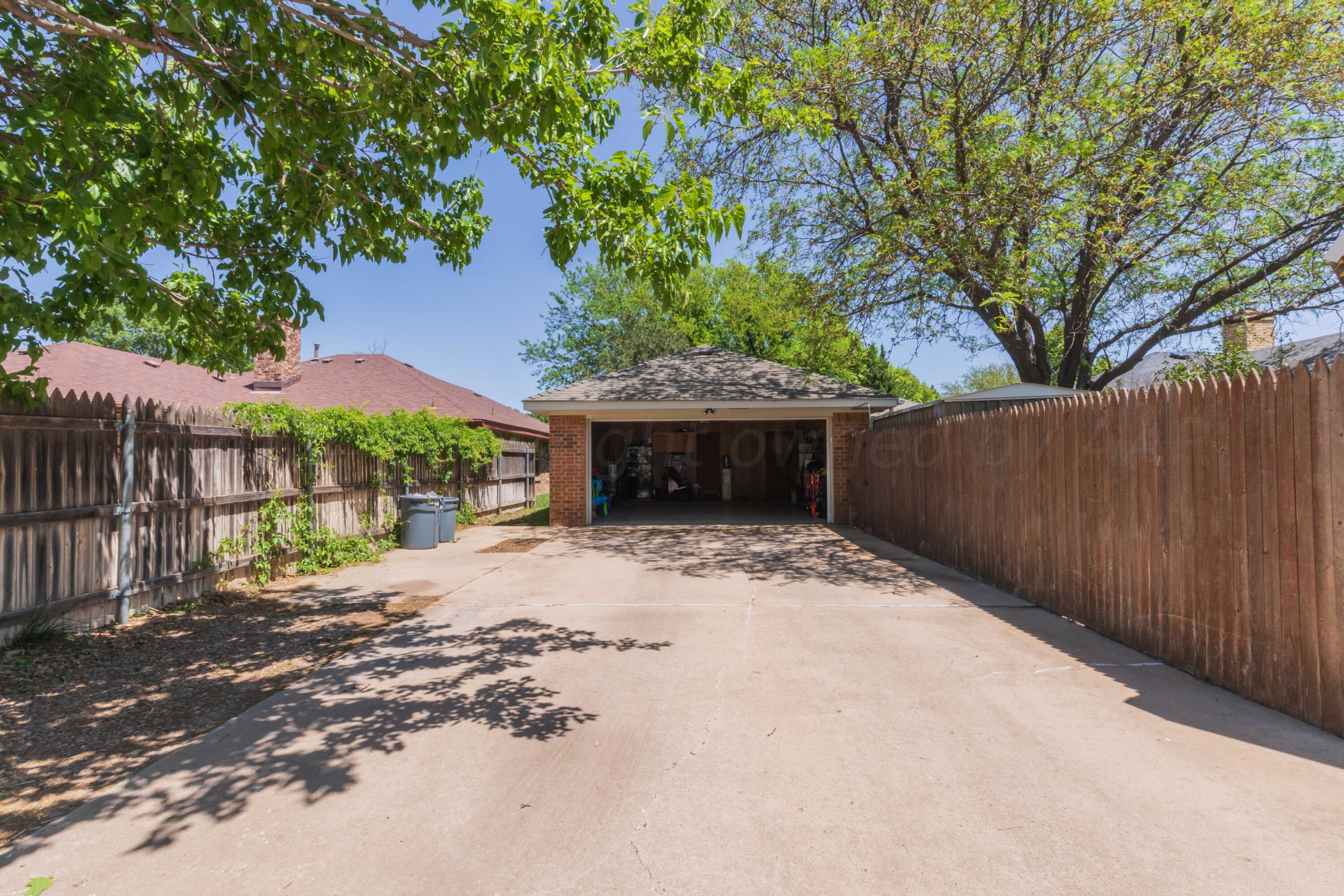 5804 Oakman Drive Amarillo, TX 79109 - Photo 48 of 48 a front view of a house with a yard and garage