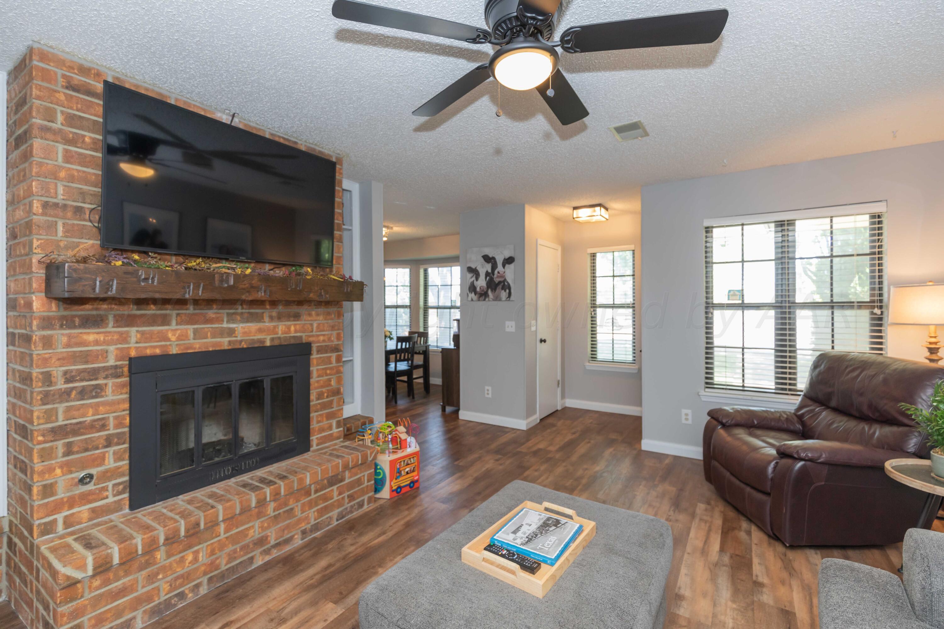 5804 Oakman Drive Amarillo, TX 79109 - Photo 6 of 48 a living room with furniture fireplace and flat screen tv