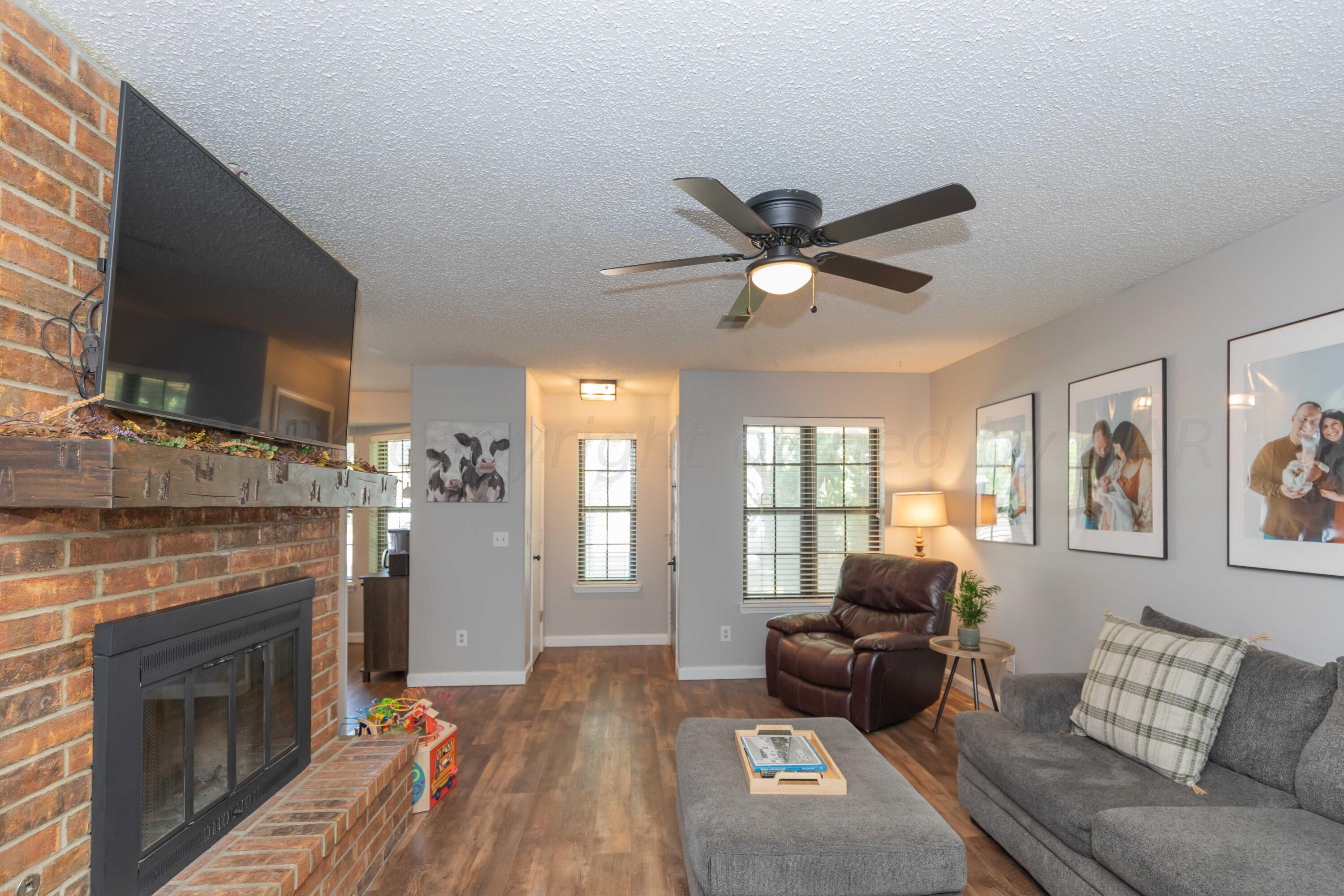 5804 Oakman Drive Amarillo, TX 79109 - Photo 10 of 48 a living room with furniture and a fireplace