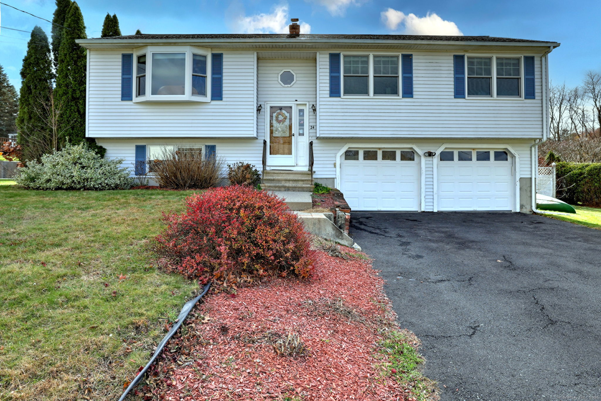 24 Windview Drive Naugatuck, CT 06770 - Photo 1 of 1 a front view of a house with a yard and garage