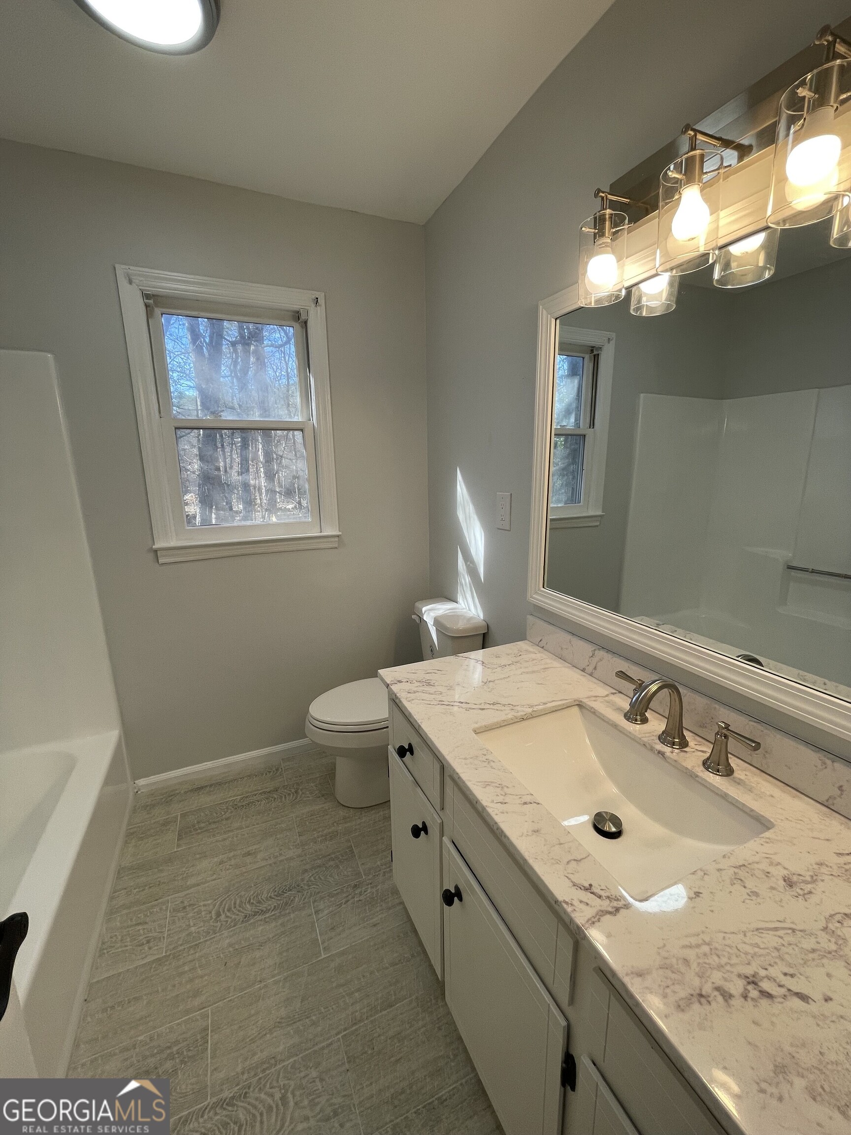 130 Springdale Court Macon, GA 31210 - Photo 11 of 14 a bathroom with a sink a toilet and a mirror