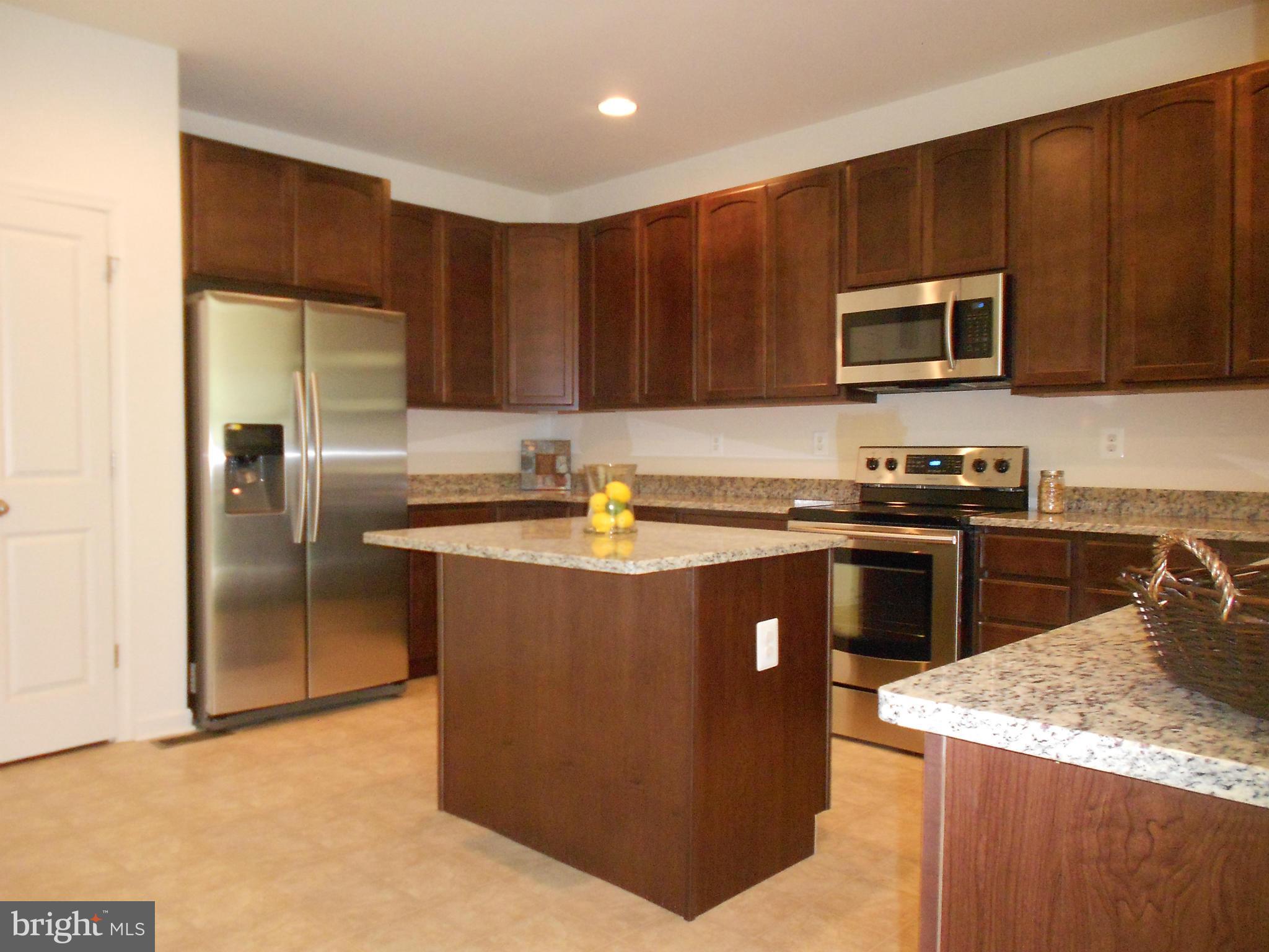 1805 Van Bibber Road Edgewood, MD 21040 - Photo 6 of 30 a kitchen with stainless steel appliances granite countertop a stove a sink and a refrigerator with wooden floor