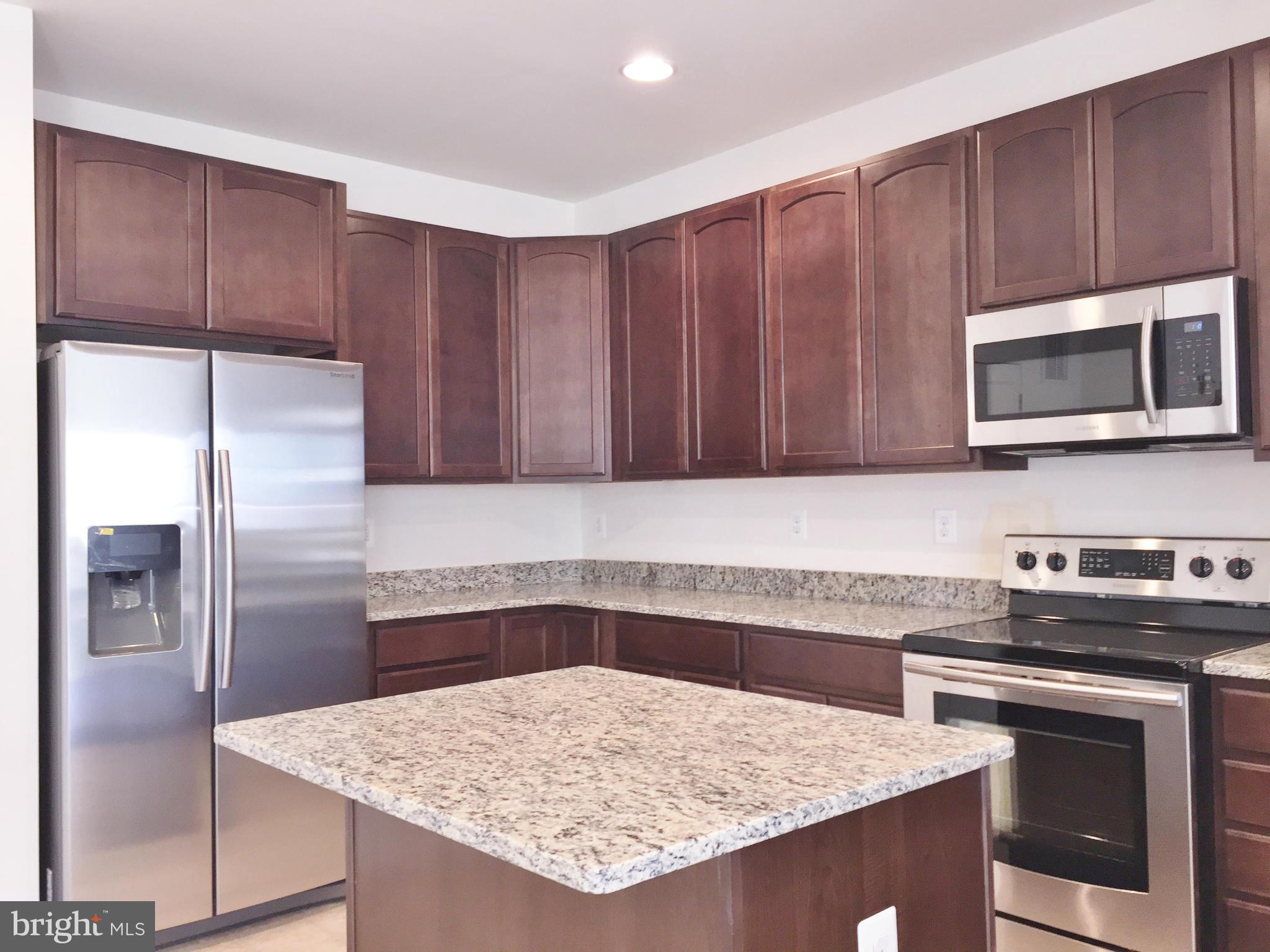 1805 Van Bibber Road Edgewood, MD 21040 - Photo 9 of 30 a kitchen with granite countertop a refrigerator a stove a sink and dishwasher