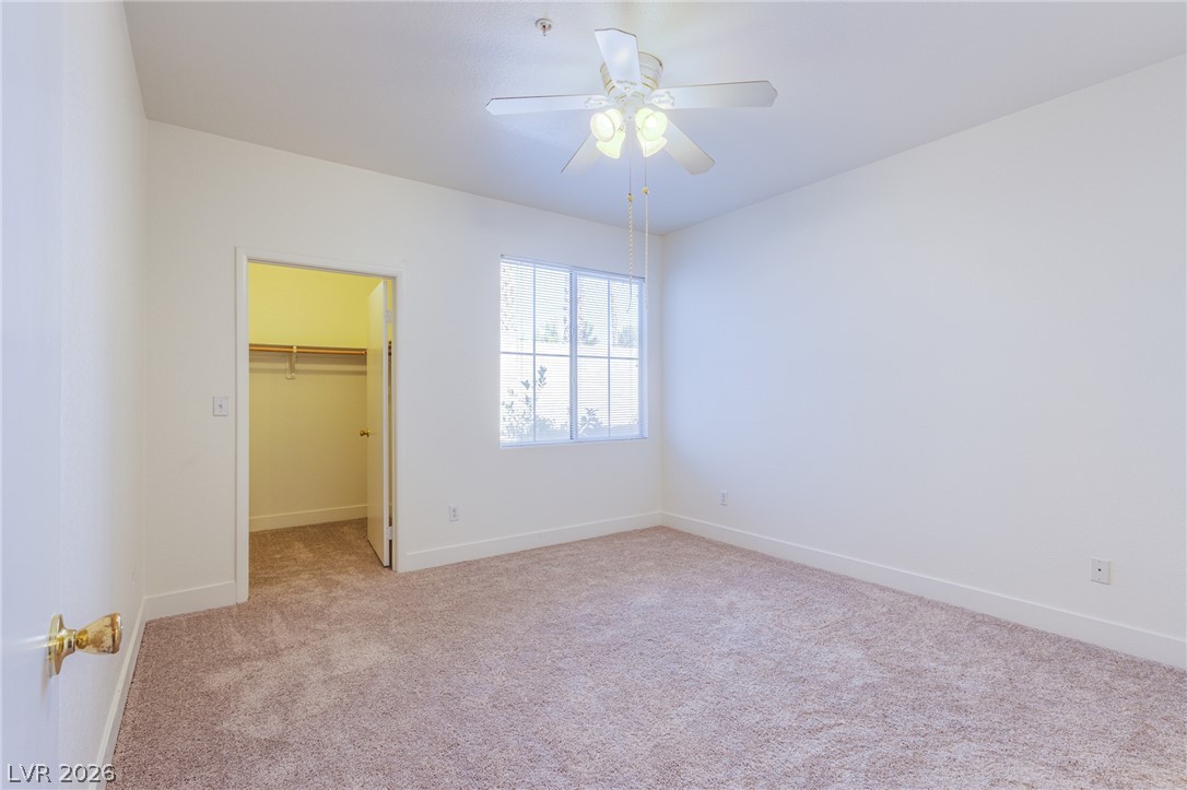 9050 West Warm Springs Road, Unit 1011 Las Vegas, NV 89148 - Photo 14 of 32 Well-lit sleeping quarters with plush carpeting and a convenient closet.